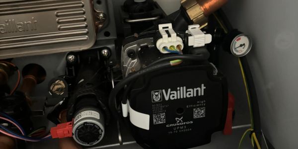 Close-up of a Vaillant heating system component with wiring and gauge.