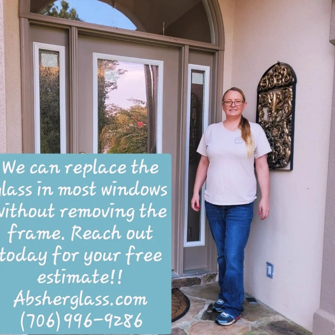 Woman standing by a door advertising glass replacement services with contact info.