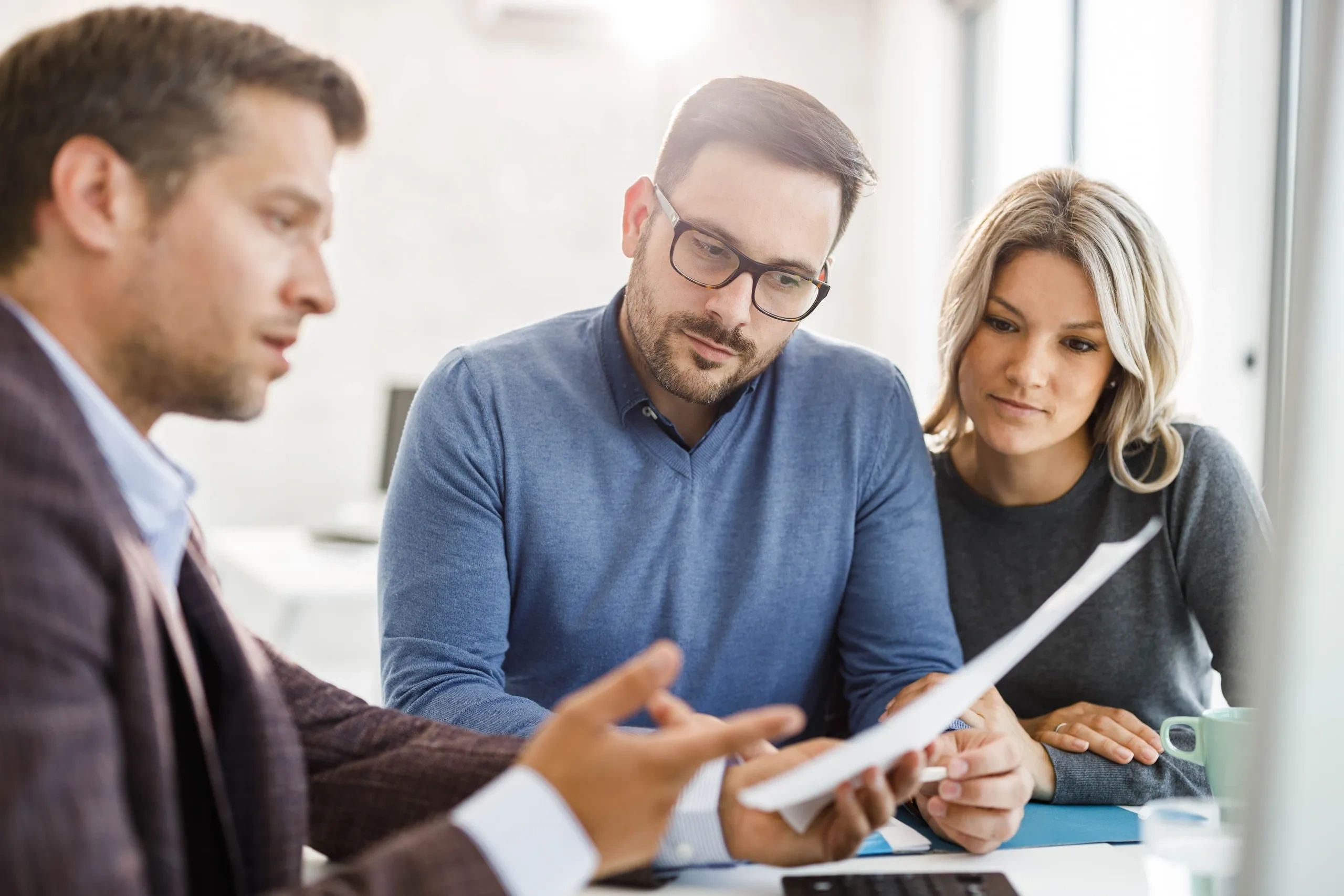 Stack of books next to pencils in a holder and a camera.
