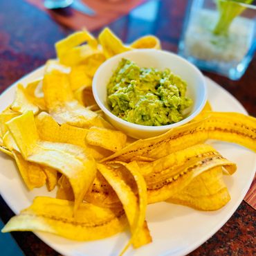 Homemade Guacamole served with platain chips.