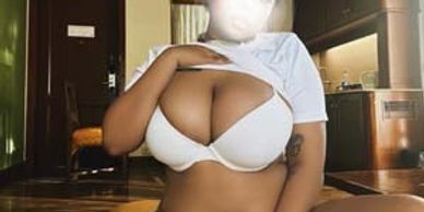 A person posing indoors in white lingerie, face blurred for privacy.
