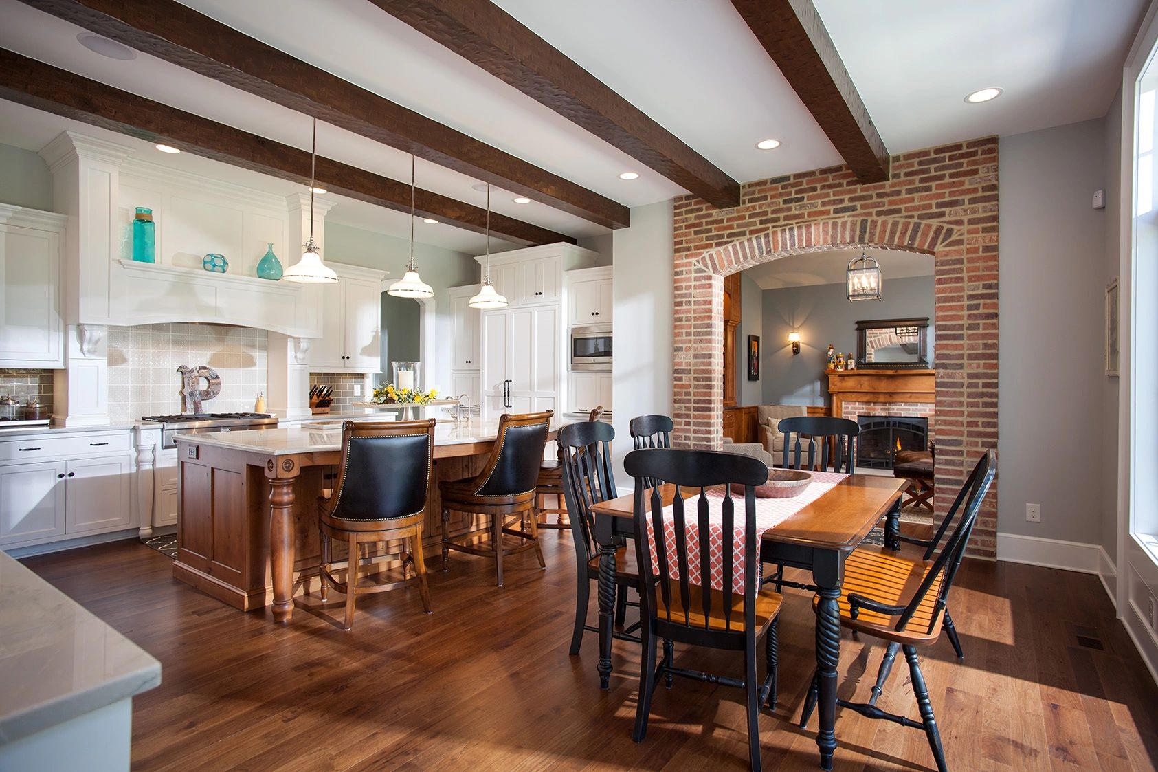 Custom home open kitchen area with exposed brick.