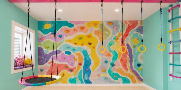 Luxury playroom design with gym rings, platform swing, climbing wall, monkey bars, and colorful mura