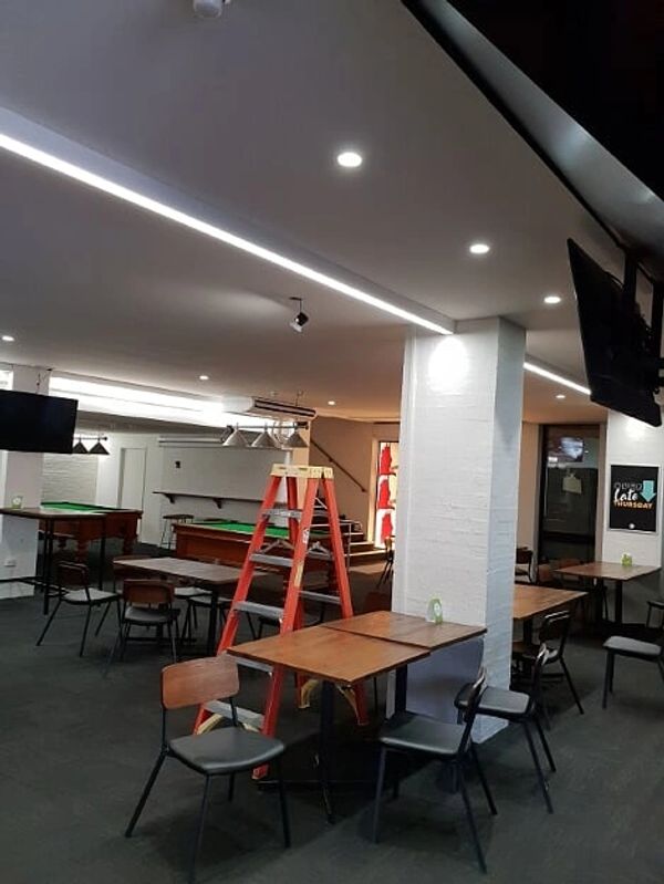LED strip lighting and down lights in a bar.