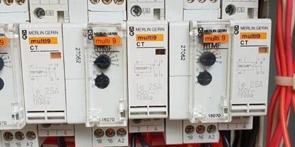 Contactors and relays in switchboard enclosure.