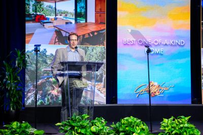 Man speaking at a real estate event.