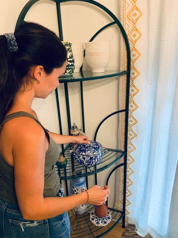 Ashley from Arranged by Ashley arranging a shelf in a dining room, Professional Organizer NJ