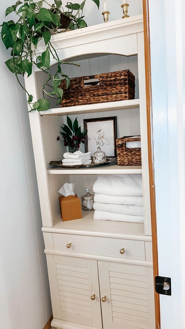 Organized and styled bathroom shelf storage by Arranged by Ashley, home organizer Jersey Shore