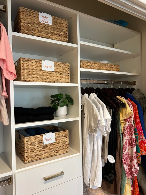 Color coordinated closet with matching hangers and baskets by Arranged by Ashley, Long Beach Island