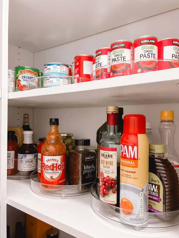 Pantry with turntables and labeled acrylic bins organized by Arranged by Ashley at the Jersey Shore.