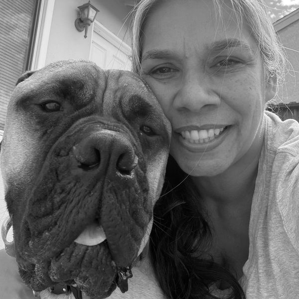 Woman smiling with her large dog.