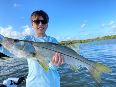 Boy holding a Snook fish in Key Largo