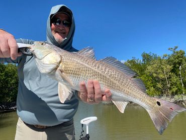 Man holding a Redfish in Key Largo.