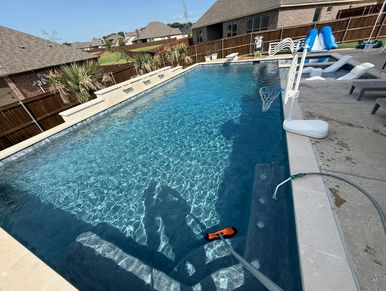 Clear backyard pool on a sunny day.