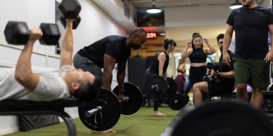 People working out with weights in a gym.