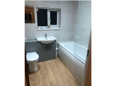 Tiled bathroom with gloss grey vanity unit