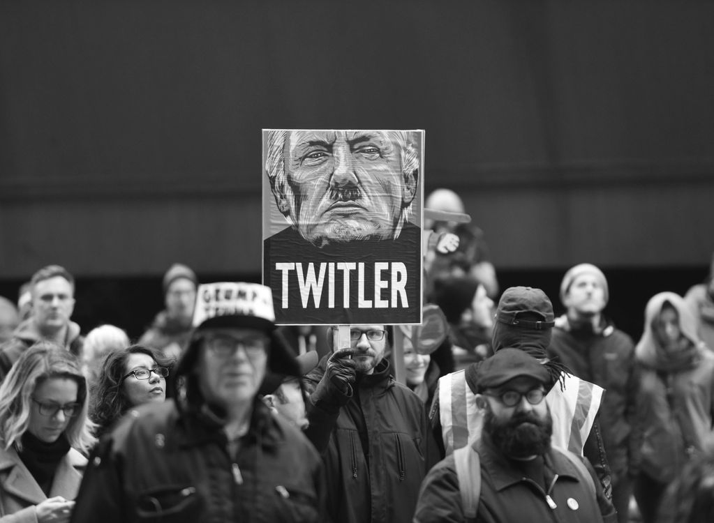 Man holding TWITLER sign in 2016 protest after Trump wins presidency