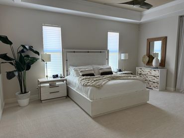 Bright and modern bedroom with neutral tones and cozy bedding.