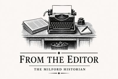 Vintage editor's desk with a typewriter and documents.