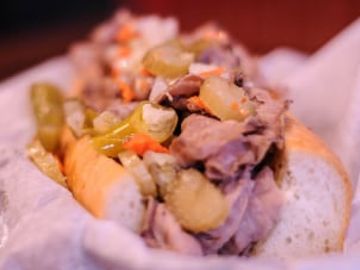 Slim's Chicago Juicy Italian Beef served on French Bread. Get it Dipped or Dry & choose Hot peppers