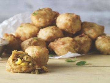 Enjoy this classic in our Battered Elote Corn Bites. We season charred corn kernels with lime, garli