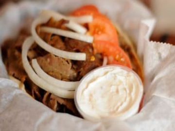 Mouth watering Gyro with Tomato, Onions, Tzatziki sauce (on the side) served on Pita bread