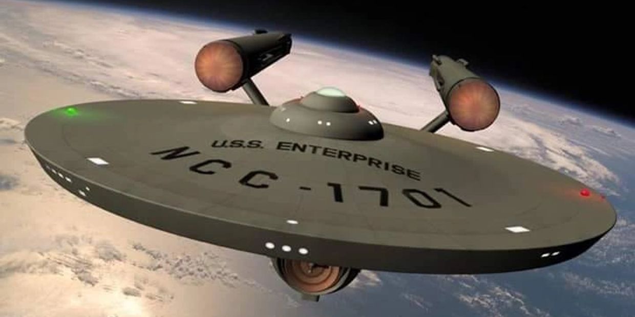 The U.S.S. Enterprise NCC-1701 spaceship orbiting a planet.