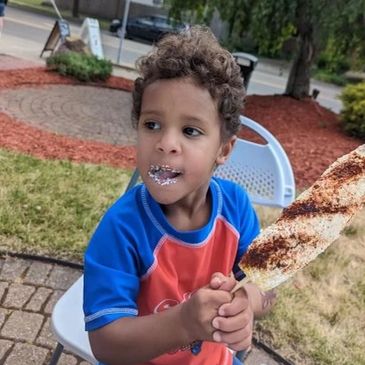 child enjoying elote from johnny lotes