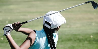 Girl swinging a golf club