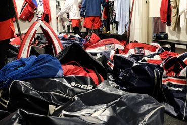 University of Arizona hockey bags in locker room at Centene Community Ice Arena.