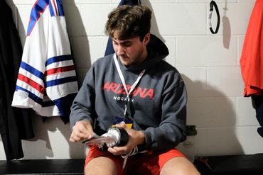 Max Meyer adjusting his skates before the first game of the 2022 ACHA National Tournament.