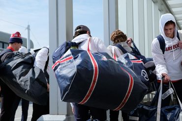 University of Arizona Wildcat hockey players gather their bags outside of St. Louis airport.