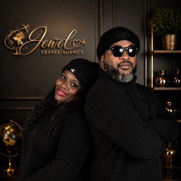 Two people posing back-to-back in a travel agency.