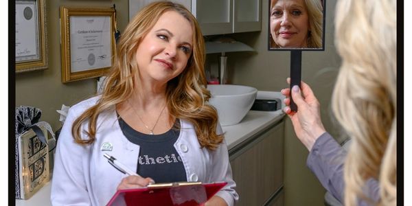 middle-aged lady looking in the mirror with another middle-aged lady looking and listening what her