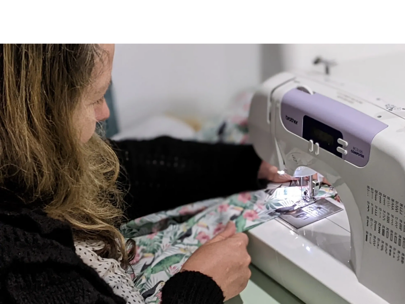 person sewing during sewing lesson