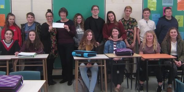 A class at Simonds high School presenting a cheque to a representative of Friends for Zambia.