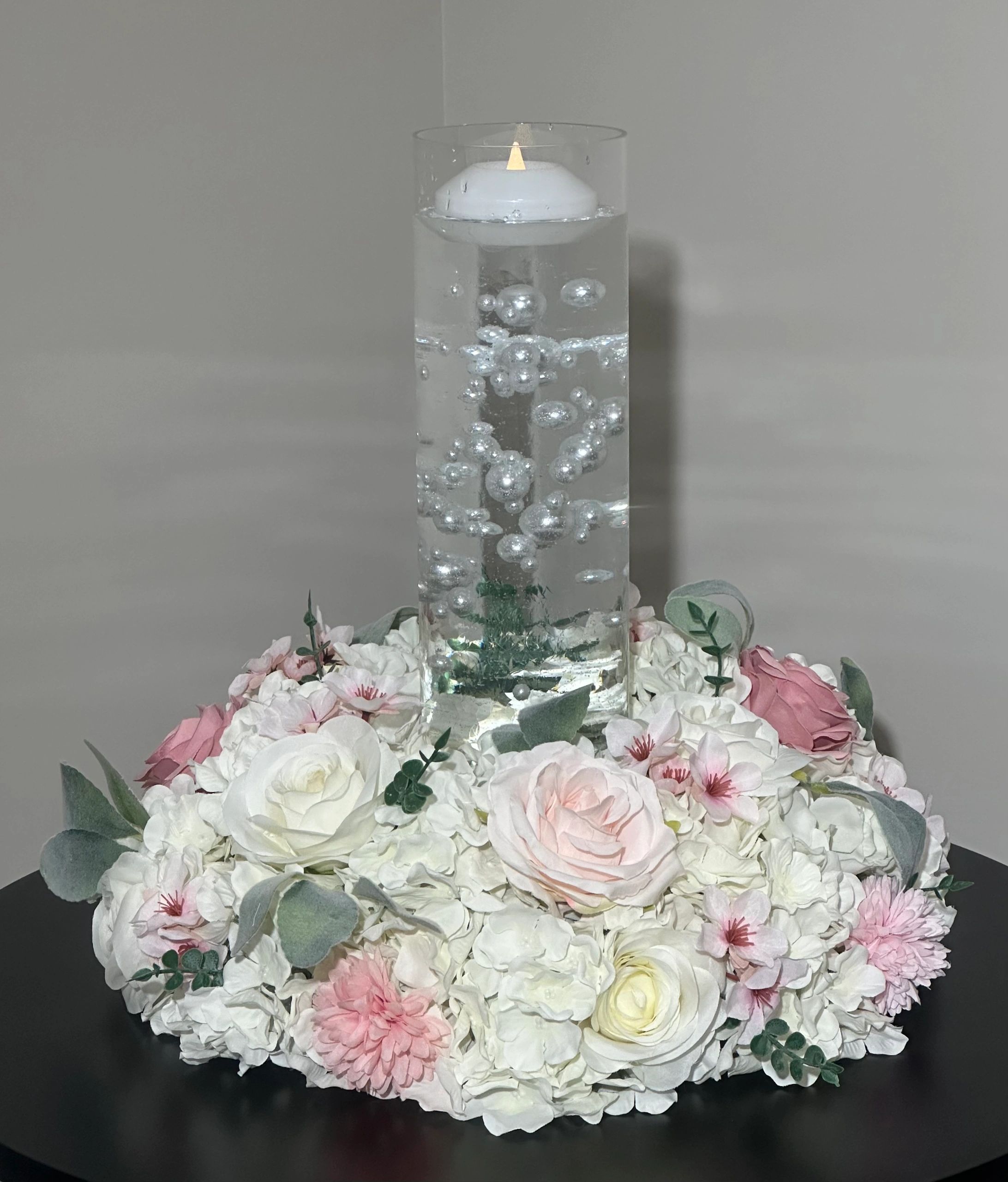Wreath with floating candle and pearls.