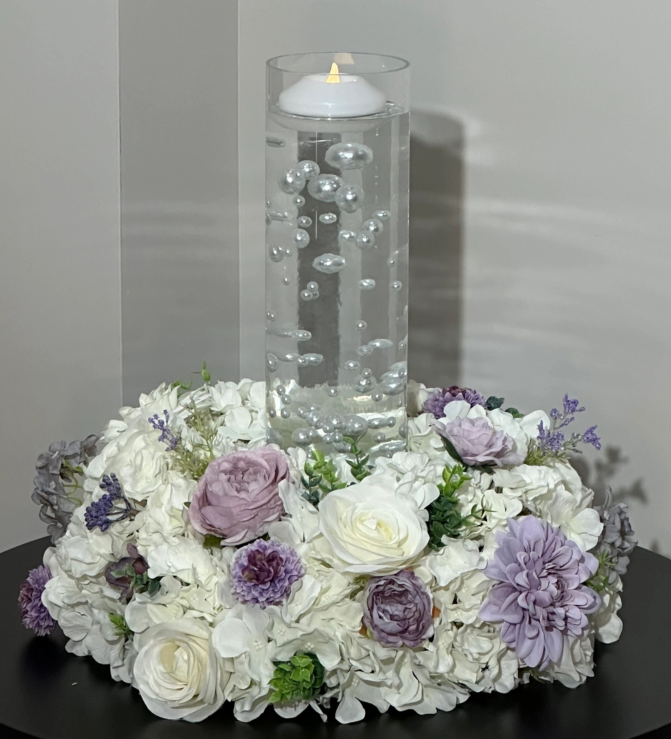 Wreath with a floating candle and pearls.