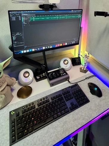 Vocal booth recording space with Logitech keyboard, mouse and LG monitor.