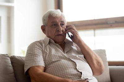 An image of an older man talking on the phone.