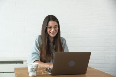 Online therapy: a picture of a woman talking to a counsellor through a computer.