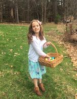 Young girl collecting EASTER eggs in a basket