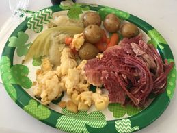 Plate of food corned beef, cabbage, carrots and potatoes on a St. Patrick's Day plate