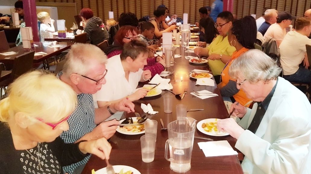Widows and widowers enjoying a meal out as part of a befriending service.