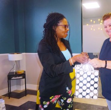 Handing goodies bag to a widow