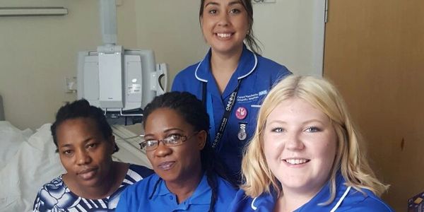 A Volunteer from The Widows Empowerment Trust helping a widow through a hospital appointment.