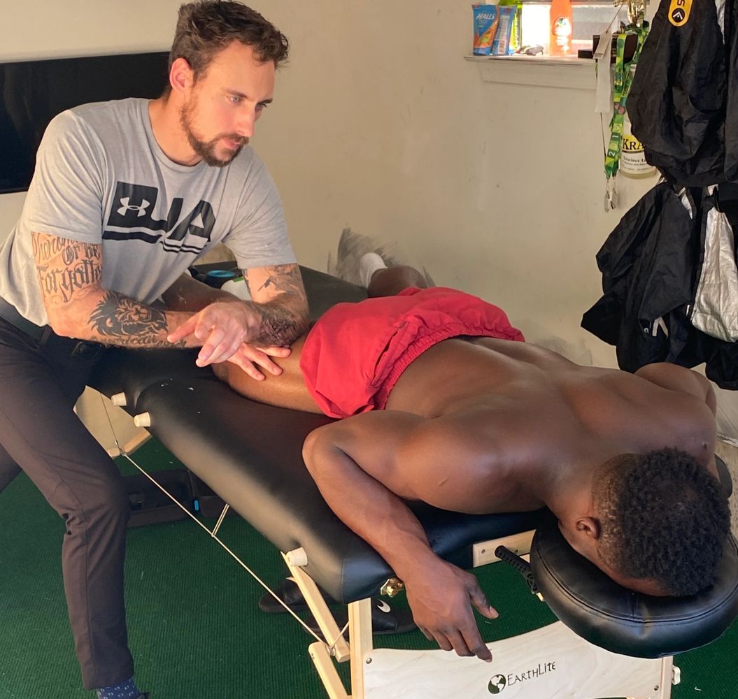 James Barbosa massaging Pro Baseball player. Baseball player gets massage by James Barbosa.