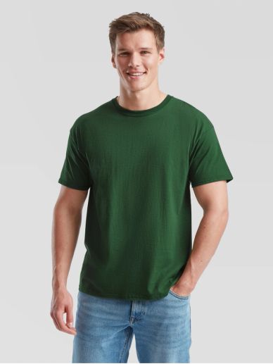 Smiling man wearing a plain green t-shirt and blue jeans.