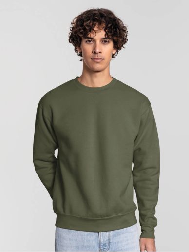 Young man wearing an olive green sweatshirt and light blue jeans.