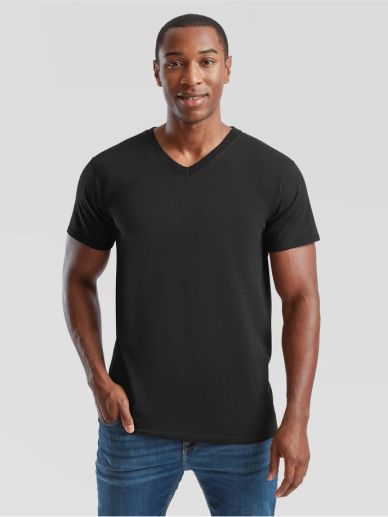 Man wearing a plain black V-neck T-shirt and blue jeans.